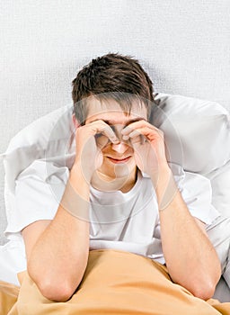 Tired Young Man in the Bed