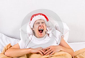 Tired Young Man in Santa Hat