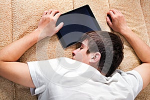 Young Man sleep with Tablet Computer
