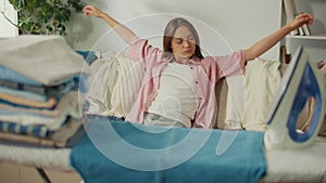 Tired Young Woman Falls on the Sofa From Weakness After Ironing the Laundry.