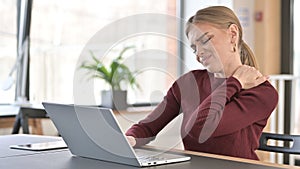 Tired Young Woman with Shoulder Pain Working in Office