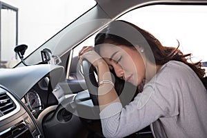 Tired young woman sleep in car, Hard work causes poor health, Sit asleep while the car is on a red light,