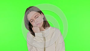 Tired Young Woman Sleeping on Green Background