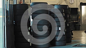 Tiremounting. Autoservice. In the automotive service, various types of car tires are neatly stacked on top of each other