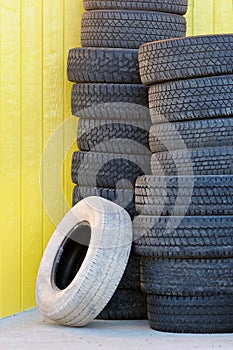 Tires against yellow wall