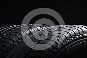 Tires ot tyres in a row on black background