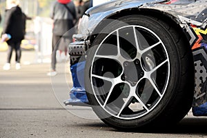 Tires of race car for driving. Drag and drift car with lower-profile tire. Racing low profile tyre with brake disc. Alloy wheel