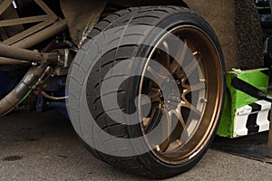 Tires of race car for driving. Drag and drift car with lower-profile tire. Racing low profile tyre with brake disc. Alloy wheel