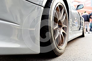 Tires of race car for driving. Drag and drift car with lower-profile tire. Racing low profile tyre with brake disc. Alloy wheel