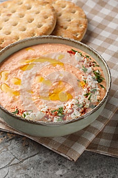 Tirokafteri Spicy Feta Dip spicy, creamy, tangy mezze from northern Greece closeup on the bowl. Vertical photo