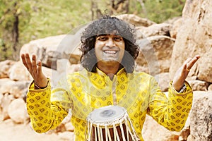 Musician Praveen Narayan playing on his tabla music instrument