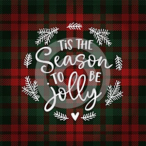 Tis the season to be jolly. Christmas greeting card, invitation with fir tree wreath. Hand lettered white text over photo
