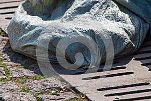 Tissue bag on the sewer grate is close