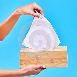 Tissue, blue background and hands with box for handkerchief for flu, sickness and sinus mockup. Healthcare, toiletries