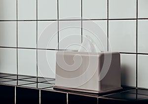 Tissue box and bathroom on ceramic tiles - the concept of cleanliness, cold and flu season