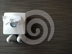 Tissue box with condiment bottle on wooden table photo