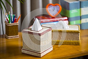 A tissue box on a wooden reading table.