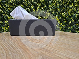 Tissue boxes on the table with leaves in the background