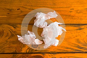 The tissue is then placed on a wooden table in the background.