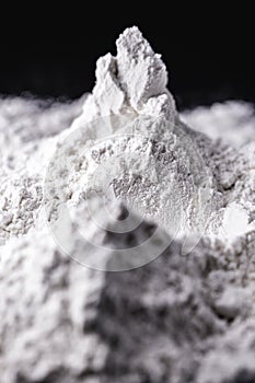 Titanium dioxide TiO2 powder for cosmetics, isolated black background