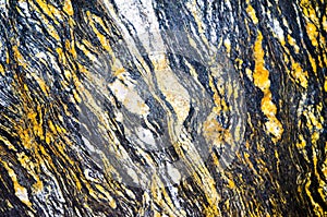 Titanius granite natural stone tile pattern in abstract color, close up.