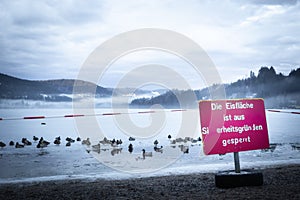 Titisee Lake, 11 March 2018: Iced over lake and warning sign