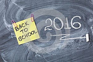 Title Back to school on piece of paper and title 2016 written by chalk on the chalkboard