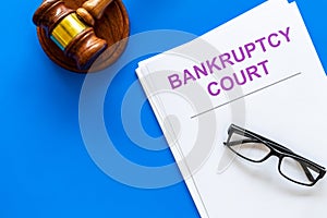 Title of documents the bankruptcy court near judge gavel on blue background top view copy space