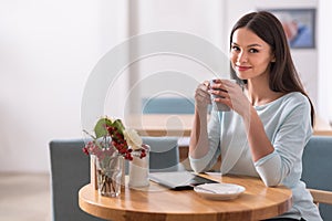 Title: Happy charming beautiful woman relaxing in a coffee shop