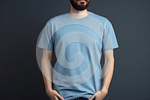 Young man in blank blue t-shirt on grey background. Mock up Ai generative