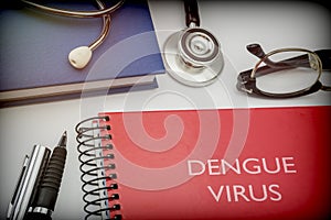 Titled red book dengue virus along with medical equipment
