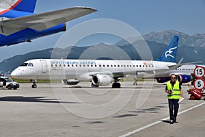 Tivat, Montenegro - June 8. 2019. Montenegro airline plane on the take-off field to international airport. Embraer 195