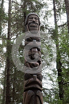 Tlingit Alaskan wood Carving man with beard and animals in trees photo