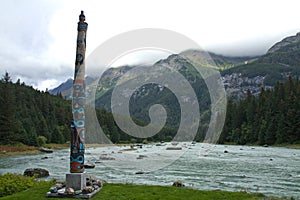 Tlingit totem on the Chilkoot River, near Haines, AK photo