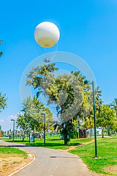 TLV balloon flying over hayarkon park in Tel Aviv, Israel photo