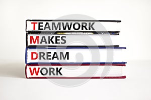 TMDW Teamwork makes dream work symbol. Concept words TMDW Teamwork makes dream work on books on beautiful white table white