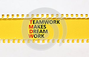 TMDW Teamwork makes dream work symbol. Concept words TMDW Teamwork makes dream work on yellow paper on beautiful white background