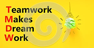 TMDW Teamwork makes dream work symbol. Concept words TMDW Teamwork makes dream work on yellow paper on beautiful yellow background