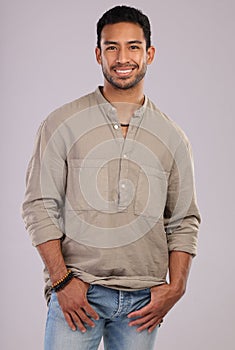 To approach life lightheartedly, is to own your power. Studio shot of a handsome young man posing against a grey photo