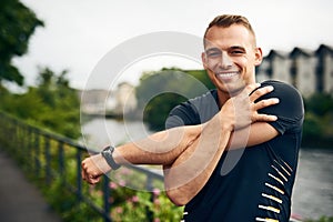 To be active means to be well. Portrait of a sporty young man stretching before a run outdoors.