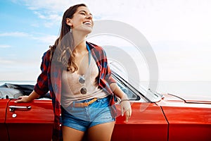 To be free is to really live. a happy young woman enjoying a summers road trip.