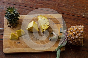 To cut pineapple on a wooden board, cleaning of pineapple, fruit pineapple.