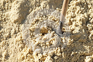 To dig in the sand.Shovel.