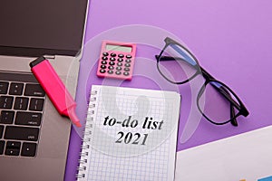 To Do List 2021 - Business office desk with notebook written in handwriting about plan listing of goals and resolutions