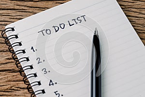 To Do List concept, pen on white paper note pad with handwritten