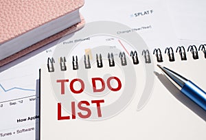 TO DO LIST text written on notepad with pen on financial documents