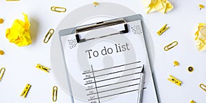 To do list on white background with office supplies. Planning future to stay productive. Flat lay. Top view. Yellow