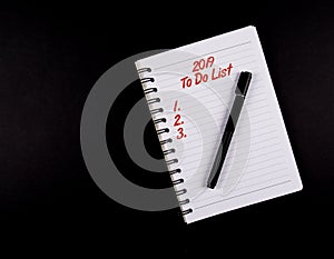 To Do List year 2019, Black Pen and a Notebook, Red text, list 1,2,3. isolated on black background, new year resolution