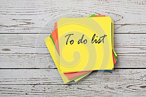 To do list on yellow adhesive note flat lay