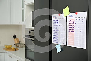 To do lists and notes on fridge in kitchen. Space for text